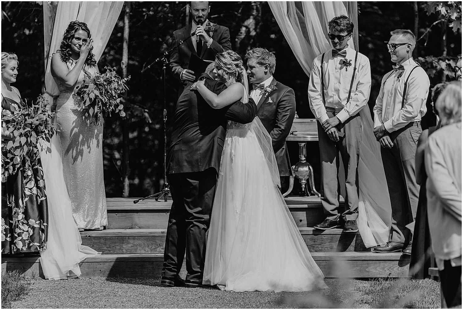 black and white of bride hugging her father at the end of the aisle at her Barn at Silver Oaks Wedding