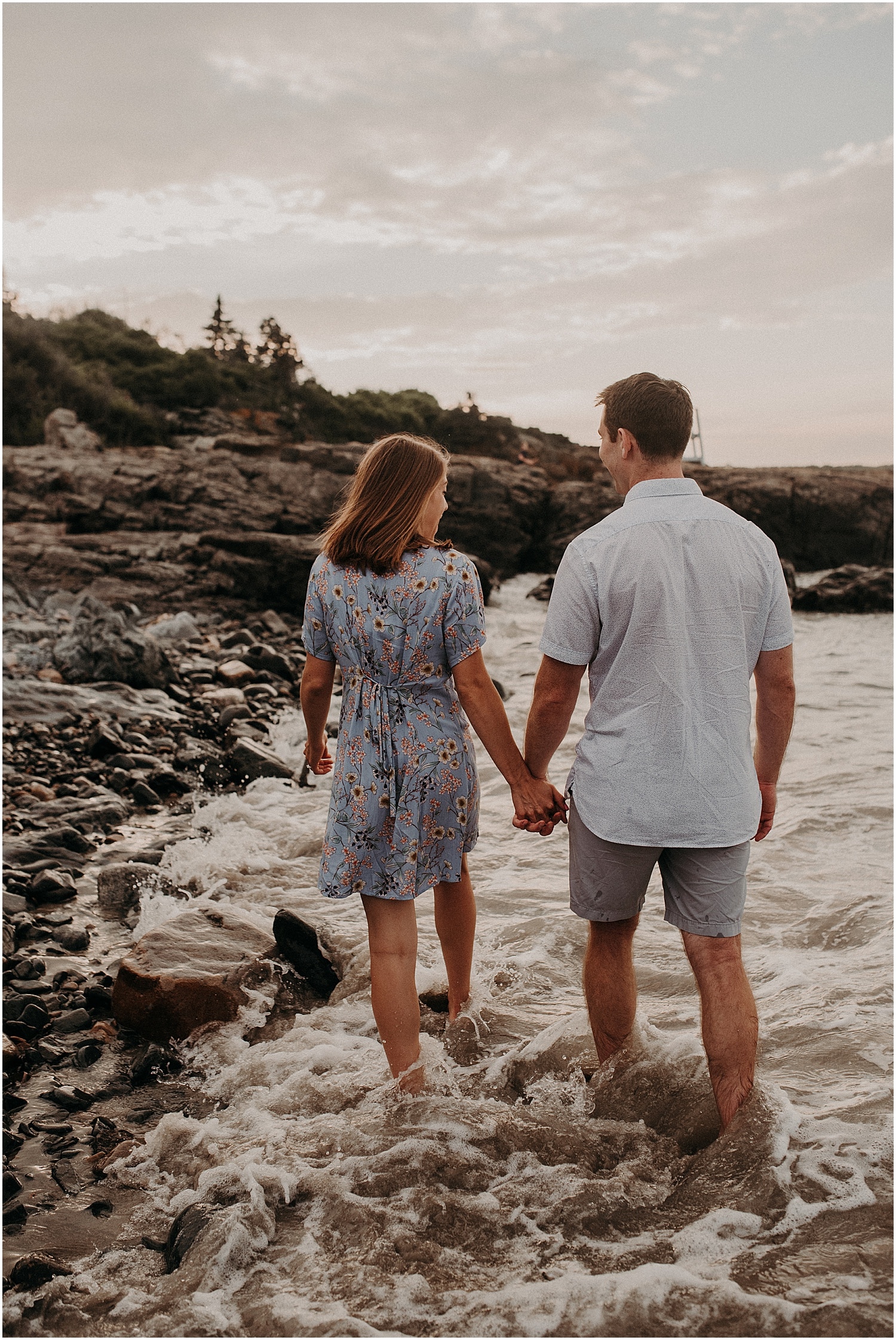 Couple walking in the water during their engagement session