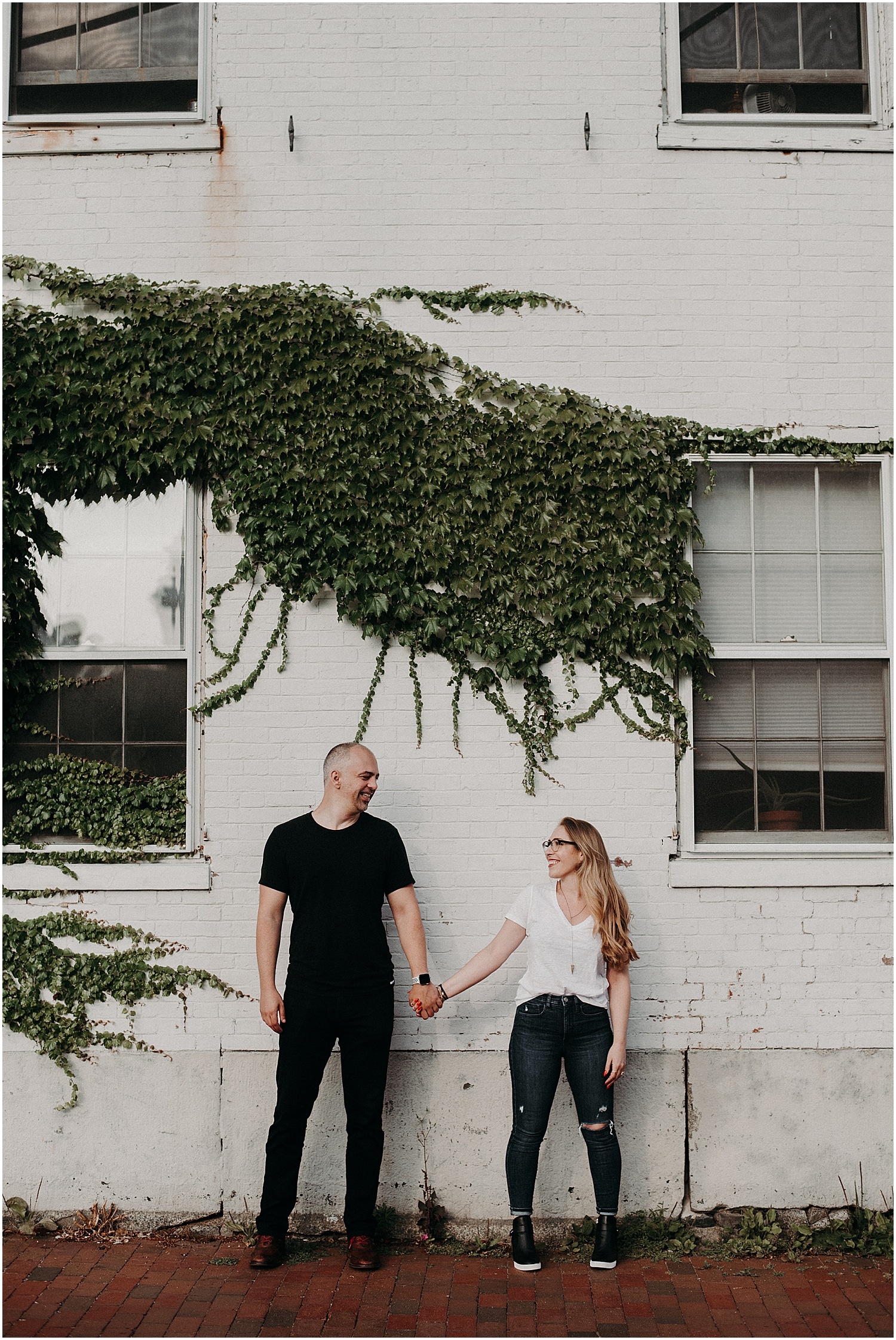 couple in front of a vine covered wall at their Portsmouth Engagement Photography