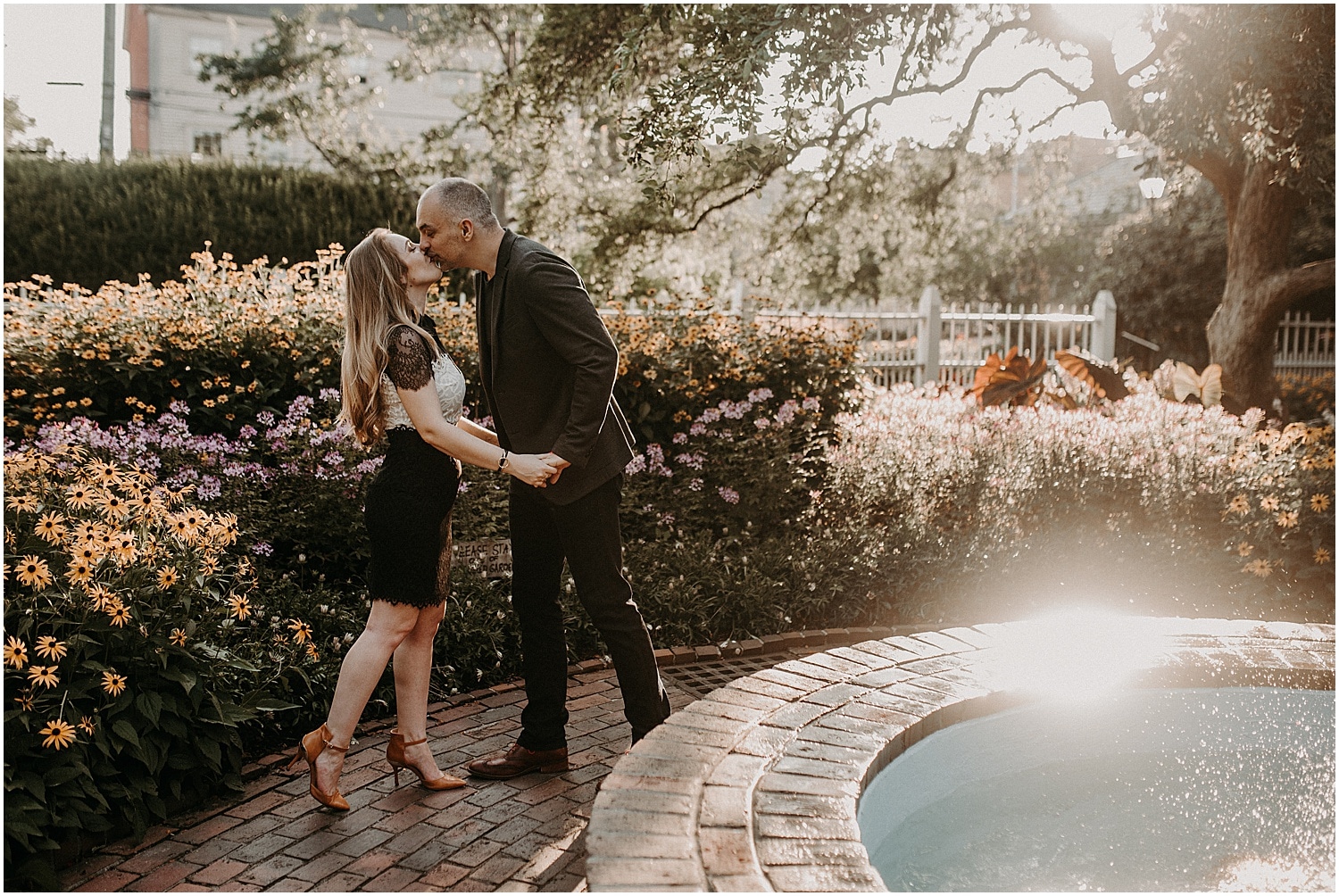 couple kissing in the garden beside the fountain at their Portsmouth Engagement Photography