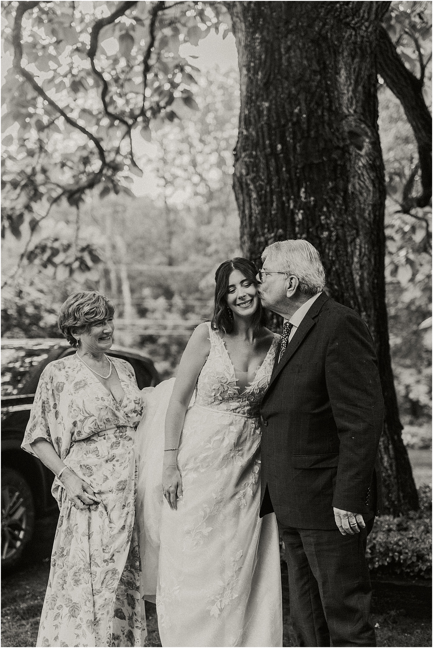 Bride stands with parents for tender moment for Katelyn Mallett Photography