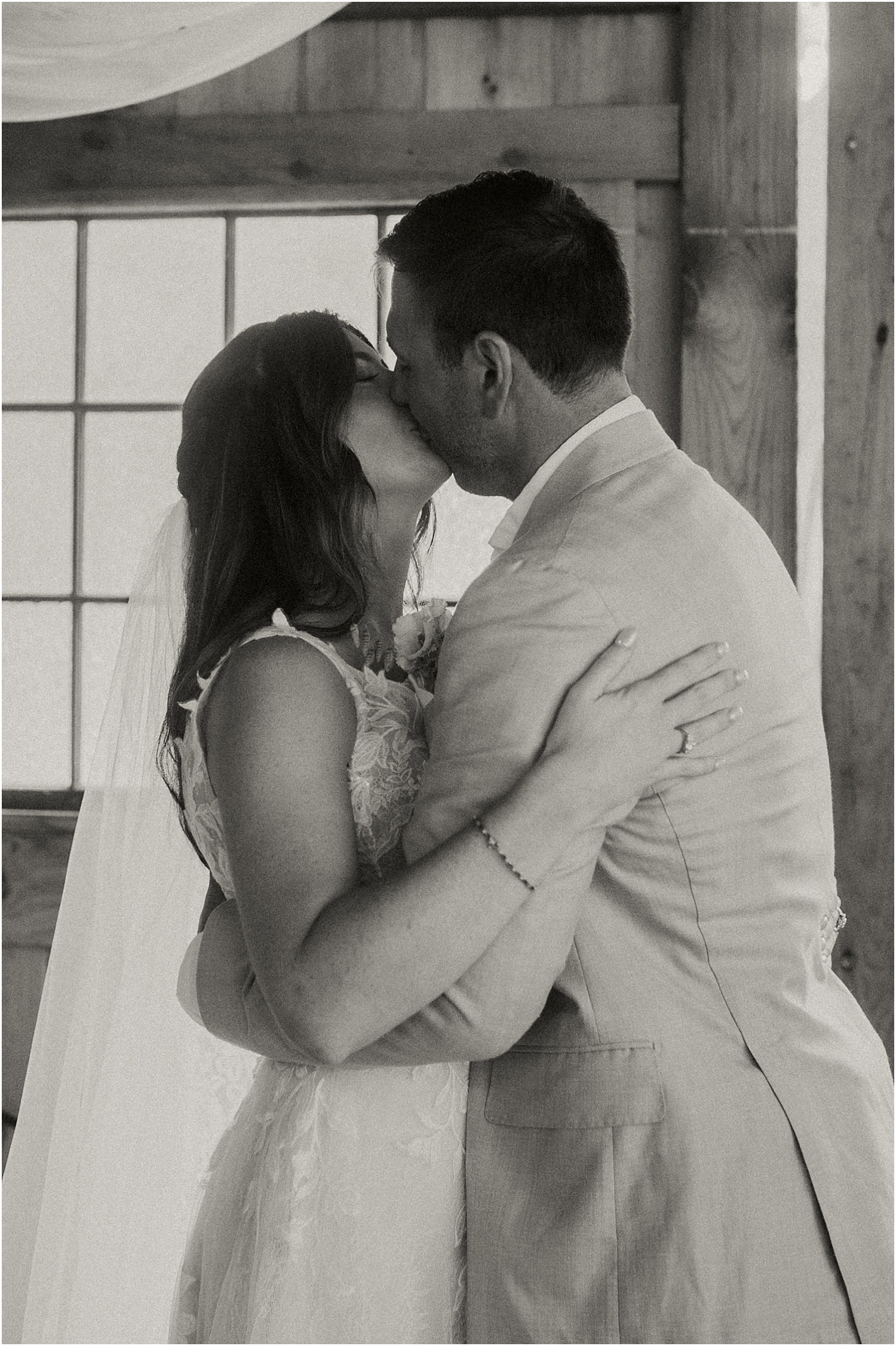 Bride and groom share a kiss for Caswell Farm Wedding Photographer
