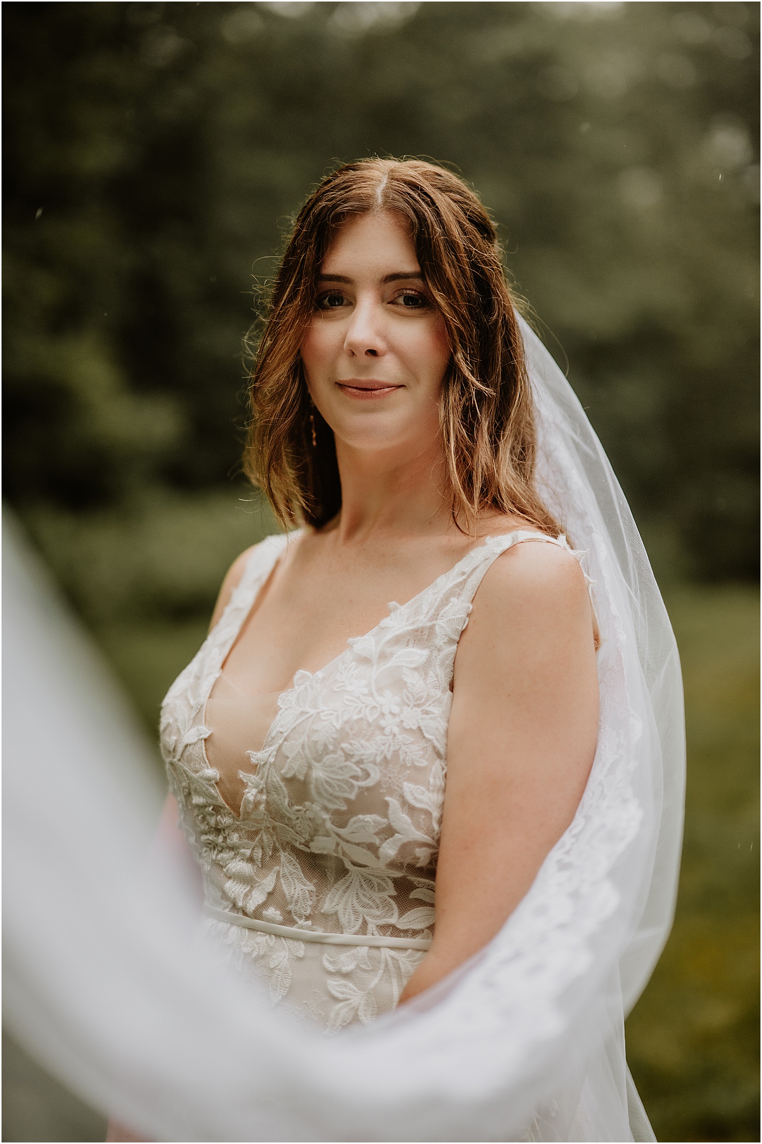 Bride pulls veil for Katelyn Mallett Photography