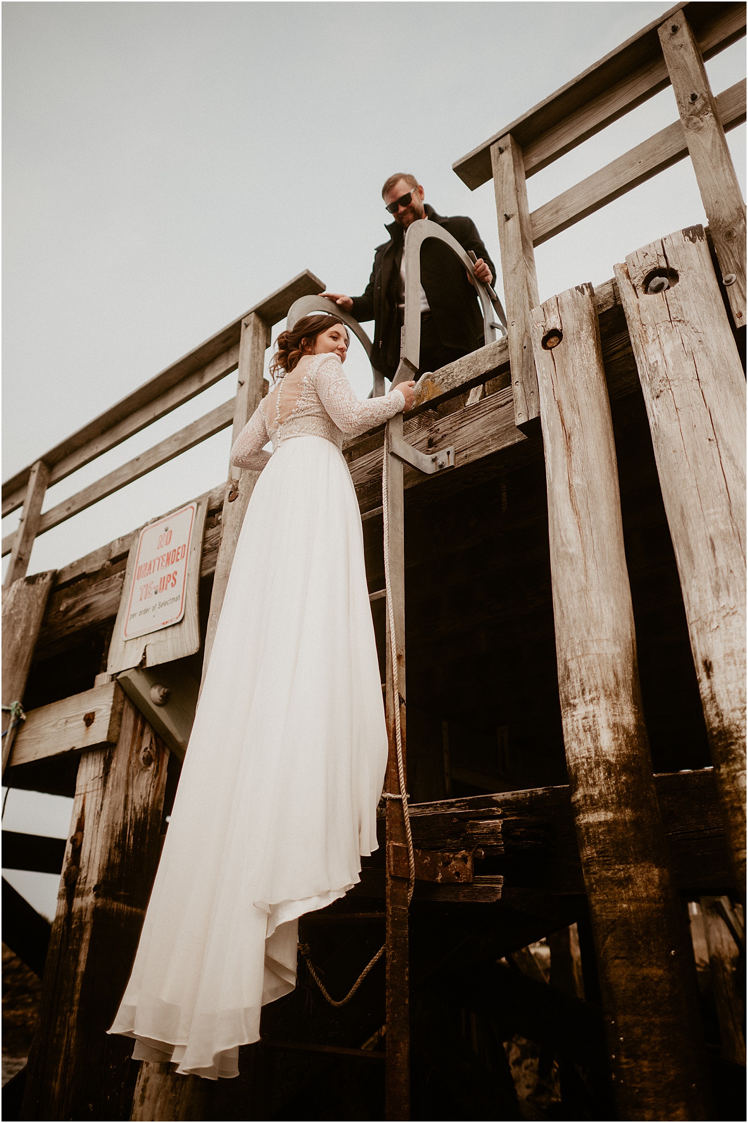 Bride walks up the stairs for Just Banded Lobster Boat Elopement