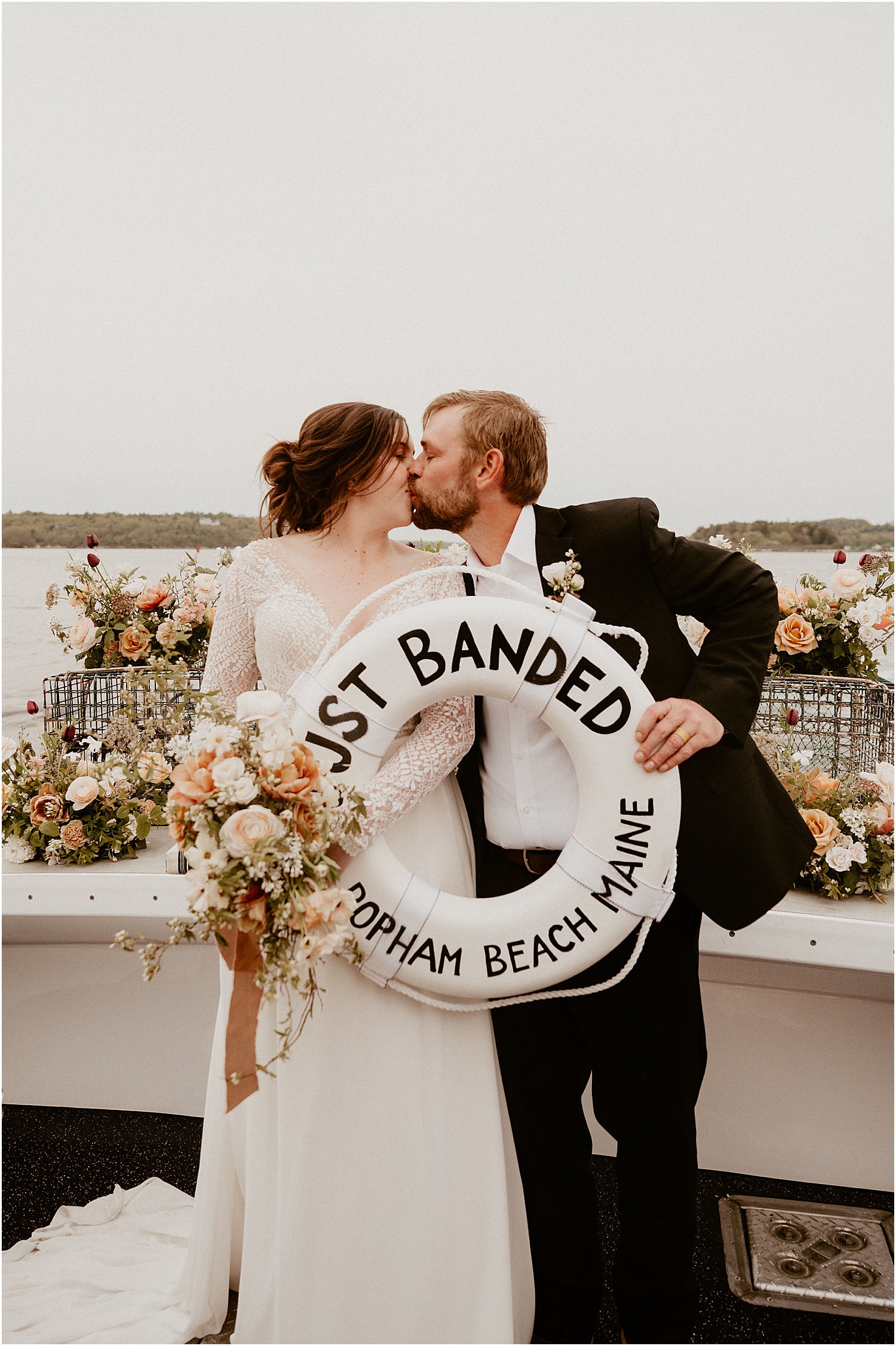Couple share a kiss on Just Banded Lobster Boat Elopement
