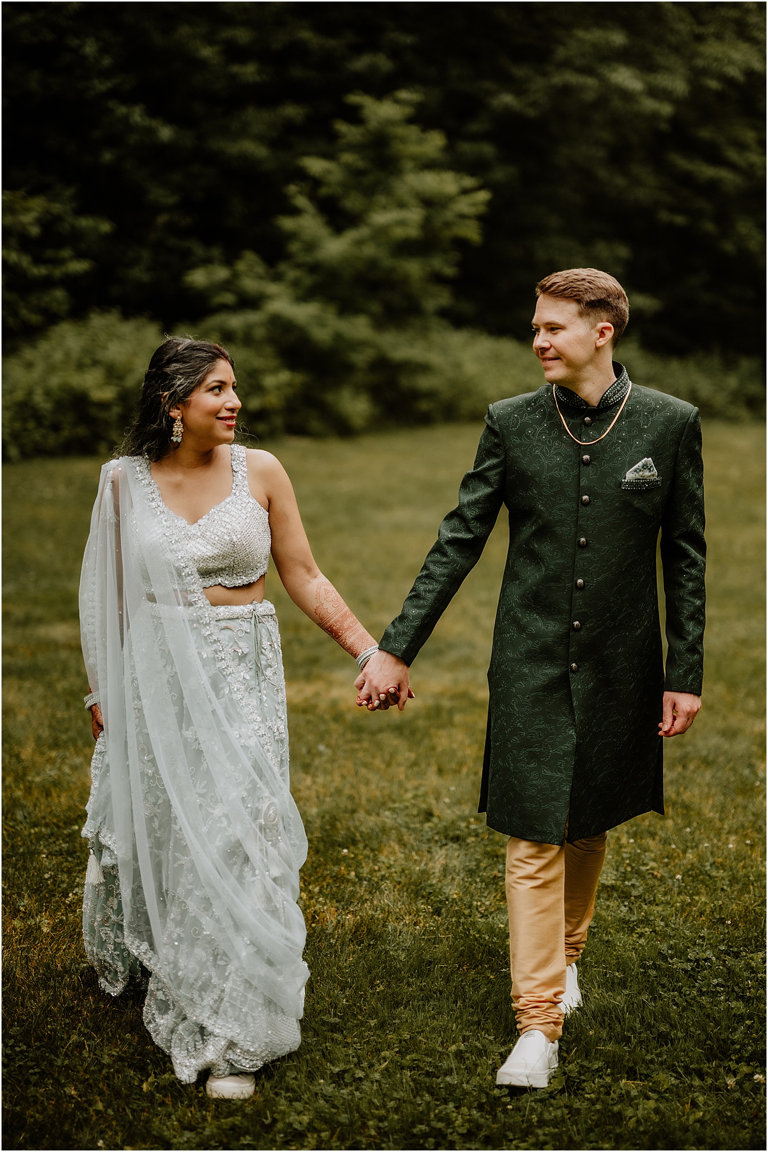 Bride and groom walk hand in hand together for Katelyn Mallett Photography